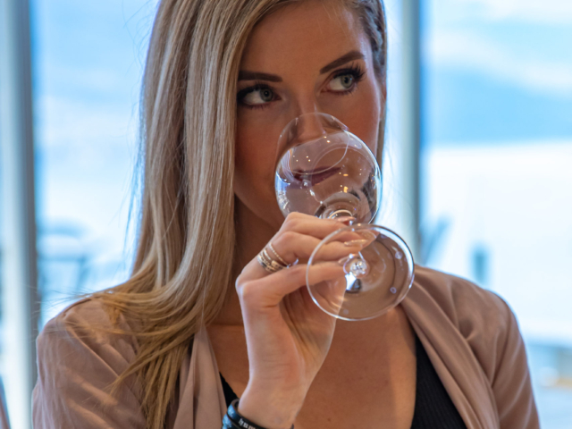 Woman drinking wine on a winery tour in Kelowna