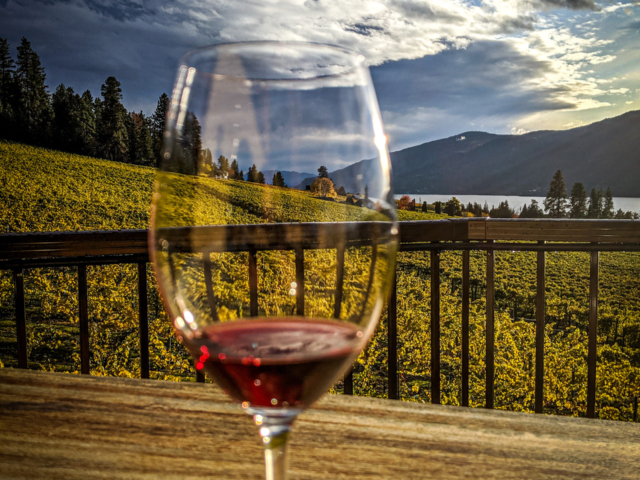 Wine glass on a table in Lake Country, British Columbia at sunset