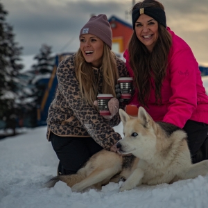 Husky dog and girls enjoying the snow and winter at Silverstar Mountain Resort