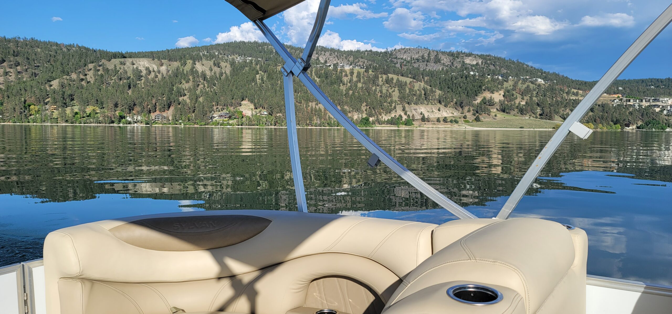 Looking at the mountains from Okanagan Lake, boat tours