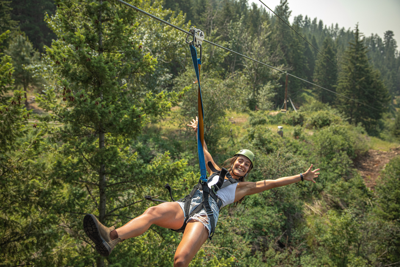 No hands!  Having a blast over the forest canopy near Oyama Ziplines in British Columbia